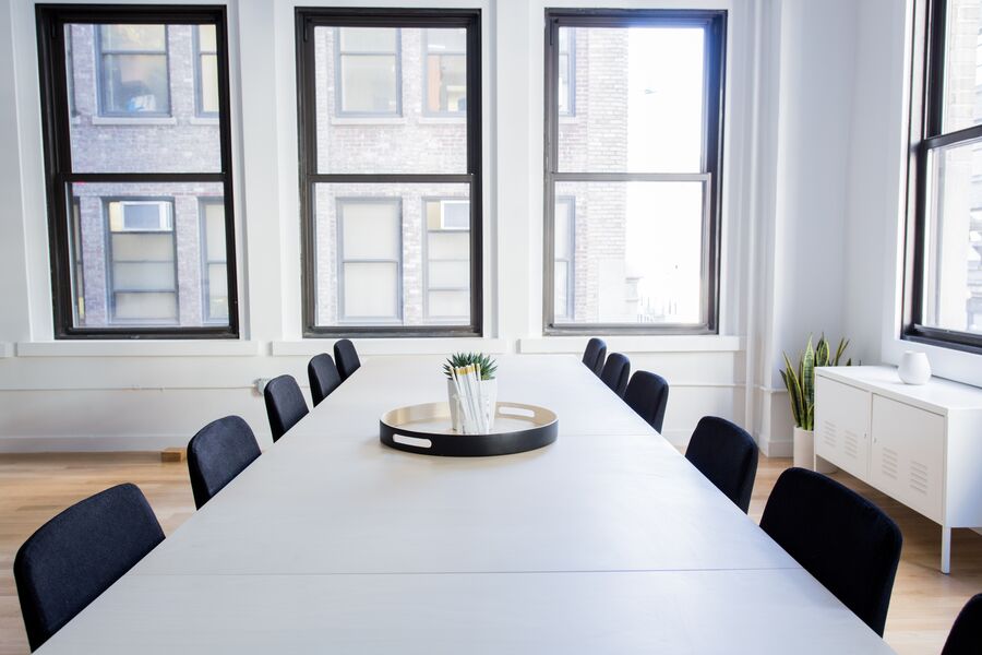 Sala de reuniones vacía con mesa y sillas